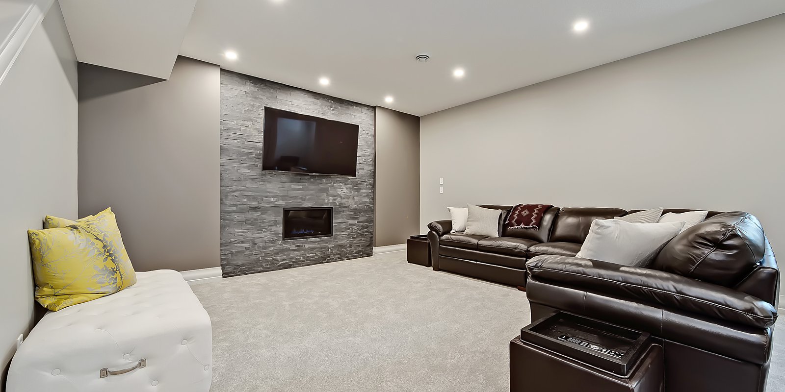 Basement with stone fireplace surround