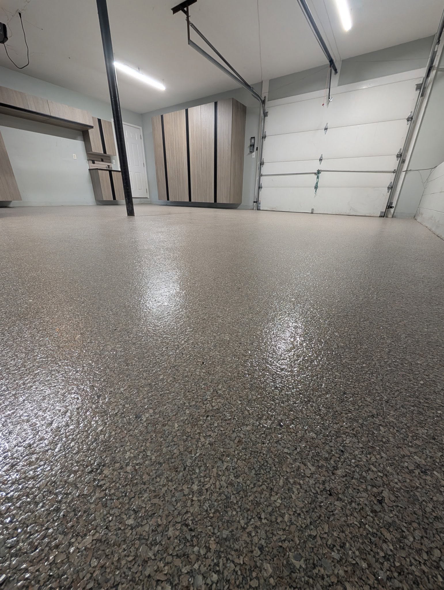 Finished garage with epoxy floor and cabinetry